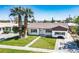 Charming single-story home with manicured lawn, a sidewalk, and mature palm trees at 633 5Th St, Boulder City, NV 89005