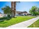 Charming home with a lush green lawn, framed by mature trees and a sidewalk, creating inviting curb appeal at 633 5Th St, Boulder City, NV 89005