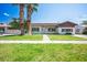 Classic single-story home featuring a lush green lawn, mature trees, and a welcoming entrance at 633 5Th St, Boulder City, NV 89005