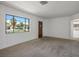 Neutral living room featuring a large window, neutral carpet, and freshly painted walls at 633 5Th St, Boulder City, NV 89005