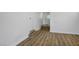A well-lit room with light wood floors, a white door, and a hallway that leads out to a backyard at 633 5Th St, Boulder City, NV 89005