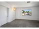 Carpeted living room featuring a large window that invites natural light, complemented by a stylish chandelier at 633 5Th St, Boulder City, NV 89005