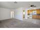 Open floor plan showcasing the living room leading into the kitchen with neutral carpet flooring at 633 5Th St, Boulder City, NV 89005