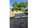 Backyard with a firepit, gravel, pavers, greenery and artificial turf at 6334 Orions Belt Peak St, North Las Vegas, NV 89031