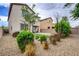 Backyard showcasing mature landscaping and a built-in fire pit at 6334 Orions Belt Peak St, North Las Vegas, NV 89031