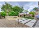 Landscaped backyard showcasing a fire pit, stone pavers, and manicured greenery at 6334 Orions Belt Peak St, North Las Vegas, NV 89031