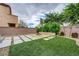 Landscaped backyard features a fire pit, artificial grass, and a stone-lined patio at 6334 Orions Belt Peak St, North Las Vegas, NV 89031