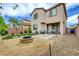 Backyard featuring a fire pit, pavers, and low-maintenance landscaping at 6334 Orions Belt Peak St, North Las Vegas, NV 89031