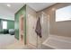 Bright bathroom featuring a tub, glass-enclosed shower, and neutral color scheme at 6334 Orions Belt Peak St, North Las Vegas, NV 89031