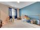 Bedroom featuring a cozy bed, large window, and playful decor, creating a fun atmosphere at 6334 Orions Belt Peak St, North Las Vegas, NV 89031