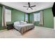 Spacious bedroom with two windows, a ceiling fan, and neutral carpet creating a serene and inviting atmosphere at 6334 Orions Belt Peak St, North Las Vegas, NV 89031
