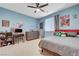 Fun bedroom with blue walls, a ceiling fan, and a comfortable bed with toys at 6334 Orions Belt Peak St, North Las Vegas, NV 89031