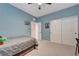 Comfortable bedroom with blue walls, carpet flooring, and ample closet space at 6334 Orions Belt Peak St, North Las Vegas, NV 89031