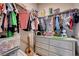Well-organized walk-in closet features hanging clothes, shelves, and a dresser for storage at 6334 Orions Belt Peak St, North Las Vegas, NV 89031