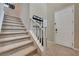 Entryway featuring a carpeted staircase, white front door, and a convenient coat rack with bench seating at 6334 Orions Belt Peak St, North Las Vegas, NV 89031