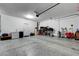 Bright two-car garage featuring an epoxy floor and ample storage space on the opposite wall at 6334 Orions Belt Peak St, North Las Vegas, NV 89031