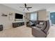 The living room features a leather sectional sofa, media center, and neutral walls with a ceiling fan at 6334 Orions Belt Peak St, North Las Vegas, NV 89031