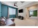Comfortable living room with a large sectional sofa, TV, and neutral carpet perfect for relaxation and entertainment at 6334 Orions Belt Peak St, North Las Vegas, NV 89031