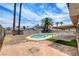 Backyard view of the pool, patio and perimeter wall with desert landscaping at 7004 Powderhorn Cir, Las Vegas, NV 89128