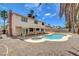 Exterior view of a home featuring a pool, covered patio, and desert landscaping at 7004 Powderhorn Cir, Las Vegas, NV 89128