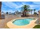 Backyard featuring a swimming pool surrounded by desert landscaping at 7004 Powderhorn Cir, Las Vegas, NV 89128