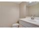 Compact bathroom with vanity and toilet featuring neutral tones at 7004 Powderhorn Cir, Las Vegas, NV 89128