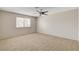 Spacious bedroom with neutral carpet and a ceiling fan for comfort at 7004 Powderhorn Cir, Las Vegas, NV 89128
