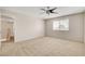 Neutral bedroom with carpet and fan, leading to other rooms at 7004 Powderhorn Cir, Las Vegas, NV 89128