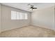 Bedroom with a large window and neutral carpet at 7004 Powderhorn Cir, Las Vegas, NV 89128