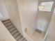 Foyer area with tiled entry, carpeted stairs and modern chandelier at 7004 Powderhorn Cir, Las Vegas, NV 89128