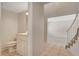 Neutral hallway with tile flooring leading to carpeted stairs and rooms at 7004 Powderhorn Cir, Las Vegas, NV 89128