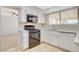 Bright kitchen featuring tile flooring and stainless steel appliances, seamlessly connected to the living space at 7004 Powderhorn Cir, Las Vegas, NV 89128
