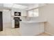 Kitchen with stainless steel appliances and white cabinetry with an eat-in bar at 7004 Powderhorn Cir, Las Vegas, NV 89128