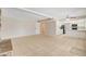 Open floor plan with tile flooring connecting the living room and kitchen for seamless entertaining at 7004 Powderhorn Cir, Las Vegas, NV 89128