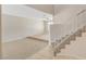 Bright living room with neutral carpet, a staircase, and natural light from the upper level at 7004 Powderhorn Cir, Las Vegas, NV 89128