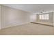 Open-concept living room with plush carpeting and ample natural light at 7004 Powderhorn Cir, Las Vegas, NV 89128