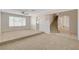 Large carpeted living room with staircase access to the second level at 7004 Powderhorn Cir, Las Vegas, NV 89128