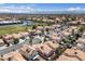 Expansive aerial view of the neighborhood showcasing the homes with lush trees and nearby mountain views at 8316 Joseph Cary Ct, Las Vegas, NV 89145