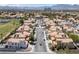 A street-level aerial view displays a tree-lined street, sidewalks, and residential homes at 8316 Joseph Cary Ct, Las Vegas, NV 89145