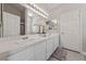 Bright bathroom features double sinks, updated vanity and tile countertop at 8316 Joseph Cary Ct, Las Vegas, NV 89145