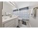 Cozy bathroom features tile countertops, white vanity and decorative shower curtain at 8316 Joseph Cary Ct, Las Vegas, NV 89145