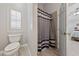 Bright bathroom with a toilet and shower stall with a decorative curtain at 8316 Joseph Cary Ct, Las Vegas, NV 89145