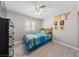 Bright bedroom with a ceiling fan, white window shutters and wood-look floors at 8316 Joseph Cary Ct, Las Vegas, NV 89145