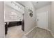 Bright entryway featuring wood floors leading into the kitchen with black appliances at 8316 Joseph Cary Ct, Las Vegas, NV 89145