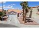 This property features a garage and desert landscaping at 8316 Joseph Cary Ct, Las Vegas, NV 89145