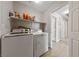 Bright laundry room with updated washer and dryer and lots of storage space at 8316 Joseph Cary Ct, Las Vegas, NV 89145