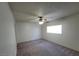 Standard bedroom with carpet flooring, neutral colored paint, ceiling fan, and a window at 854 Stainglass Ln, Las Vegas, NV 89110