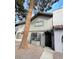 Quaint townhome showcasing a covered entryway and low-maintenance landscaping at 854 Stainglass Ln, Las Vegas, NV 89110