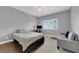This bedroom offers tiled floor, shutters, a cozy sofa, a chic chandelier and neutral paint at 855 N Stephanie St # 2121, Henderson, NV 89014