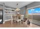 Cozy dining area adjacent to the kitchen, featuring built-in shelving, a modern light fixture, and sliding doors to a balcony at 855 N Stephanie St # 2121, Henderson, NV 89014